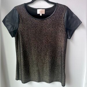 Shimmery gold t-shirt with black pleather sleeves and collar